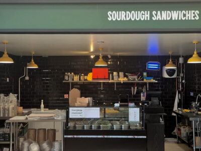 Crisp and Melt unit The Shed Bordon - shpowing the black tiled interior, with frontage above, and counters.