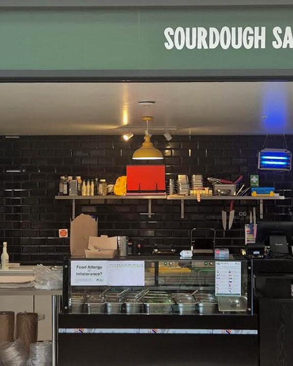 Crisp and Melt unit The Shed Bordon - shpowing the black tiled interior, with frontage above, and counters.